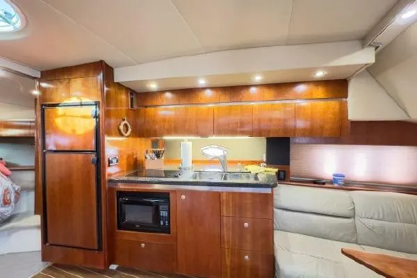 Slide: The Image of Luxurious 2005 Cruisers 420 yacht interior with modern kitchen and cozy seating area. - 29