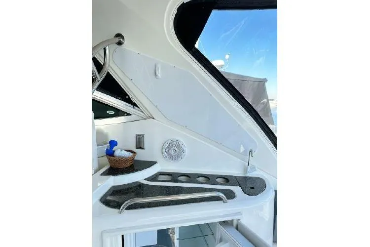 Slide: The Image of 2005 Cruisers 420 yacht interior with cup holders and storage area. - 34