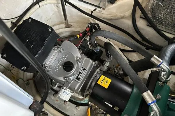 Slide: The Image of Engine compartment of a 2005 Cruisers 420 boat, showcasing mechanical components and wiring. - 43