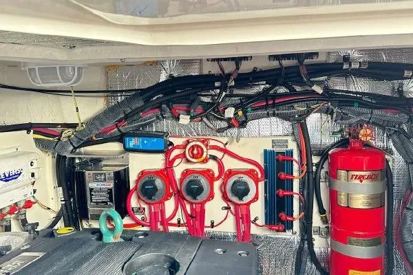 Slide: The Image of Engine room of a 2005 Cruisers 420 yacht with wiring and fire extinguisher. - 44