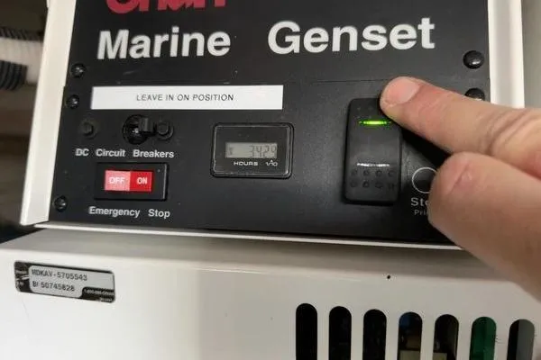Slide: The Image of Control panel of a 2005 Cruisers 420 marine generator with operational indicators. - 45