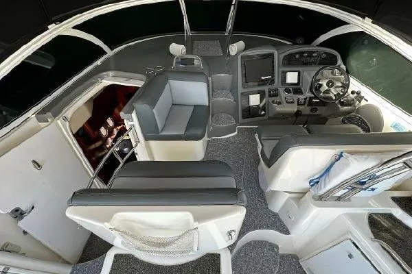 Slide: The Image of 2005 Cruisers 420 yacht cockpit with modern helm, seating, and cabin entrance. - 52