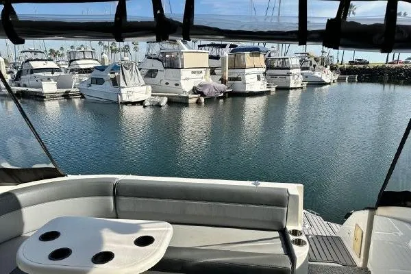 Slide: The Image of 2005 Cruisers 420 yacht interior with marina view, featuring docked boats and calm water. - 56