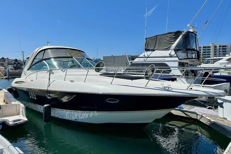 The Image of 2005 Cruisers 420 yacht docked at marina under clear blue sky. - 0