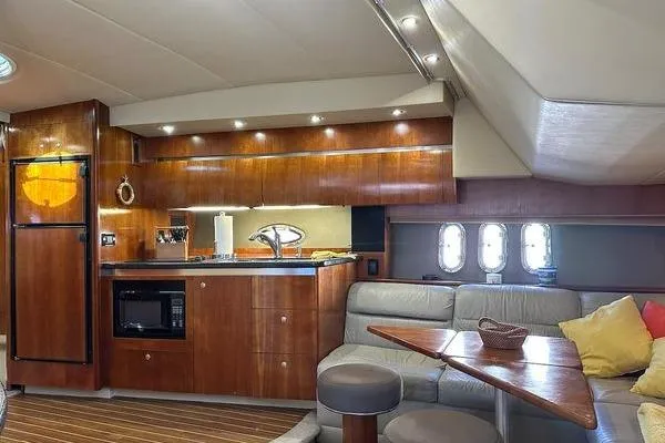 Slide: The Image of Luxurious 2005 Cruisers 420 yacht interior with modern kitchen and cozy seating area. - 11