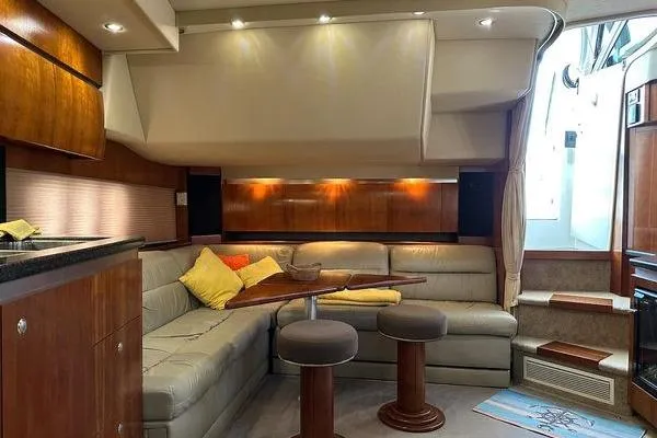 Slide: The Image of Luxurious interior of 2005 Cruisers 420 yacht with plush seating and elegant wood finishes. - 14