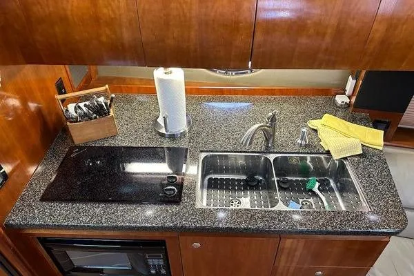 Slide: The Image of Luxurious 2005 Cruisers 420 yacht kitchen with granite countertop and dual sink. - 15