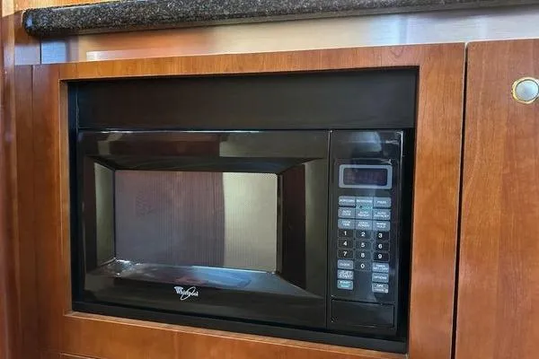 Slide: The Image of Built-in microwave in 2005 Cruisers 420 yacht kitchen with wooden cabinetry. - 18
