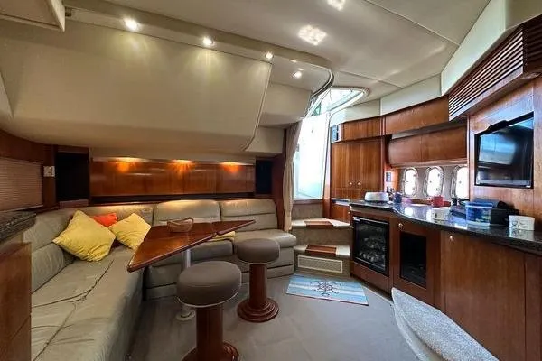 Slide: The Image of Luxurious 2005 Cruisers 420 yacht interior with elegant wood finishes and cozy seating area. - 22