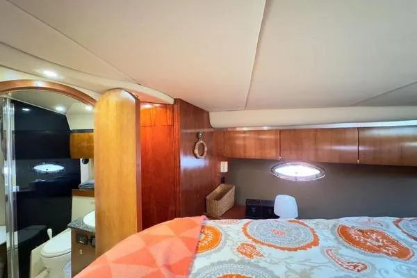 Slide: The Image of Luxurious interior of 2005 Cruisers 420 yacht with elegant wood finishes and cozy bedding. - 26