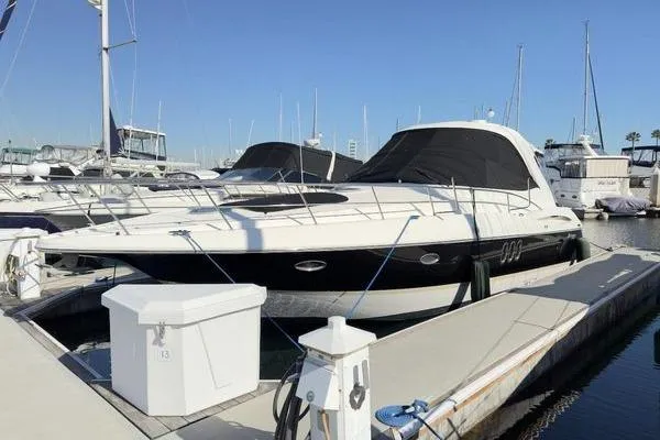 Slide: The Image of 2005 Cruisers 420 yacht docked at marina under clear blue sky. - 30