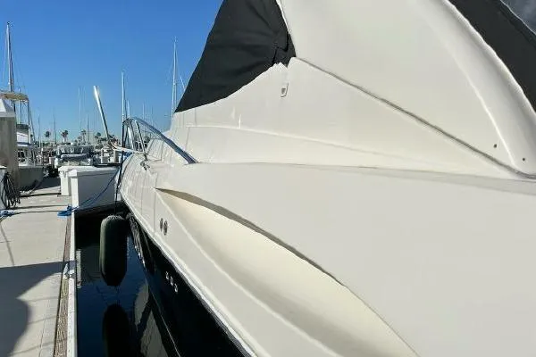Slide: The Image of 2005 Cruisers 420 yacht docked at marina under clear blue sky. - 31