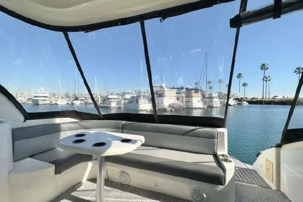 Slide: The Image of 2005 Cruisers 420 yacht interior with seating area, table, and marina view. - 38