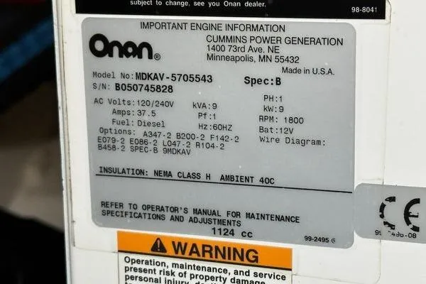 Slide: The Image of Label on Onan generator, model MDKAV-5705543, with specifications and warning notice. - 39