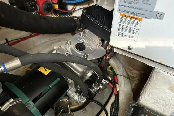 Slide: The Image of Engine compartment of a 2005 Cruisers 420 boat, showing mechanical components and wiring. - 42