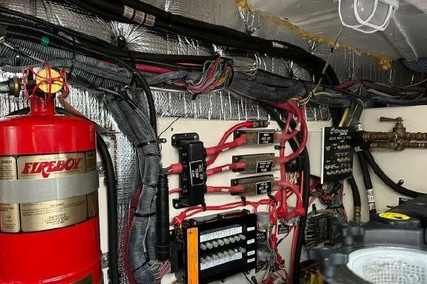 Slide: The Image of Engine room of 2005 Cruisers 420 yacht with wiring and fire extinguisher system. - 46