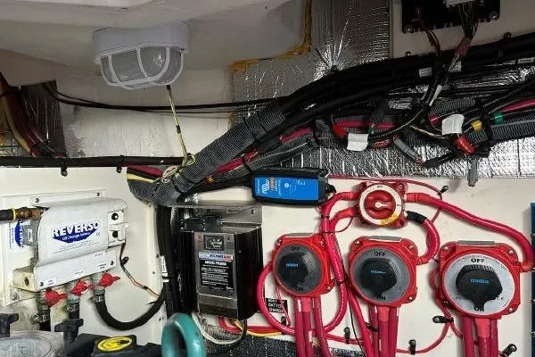 Slide: The Image of Engine room of a 2005 Cruisers 420 boat with wiring and control panels. - 47