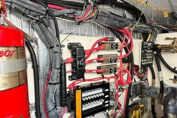 Slide: The Image of Electrical wiring and components inside a 2005 Cruisers 420 boat engine room. - 48