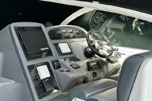 Slide: The Image of 2005 Cruisers 420 helm with modern navigation equipment and steering wheel. - 8