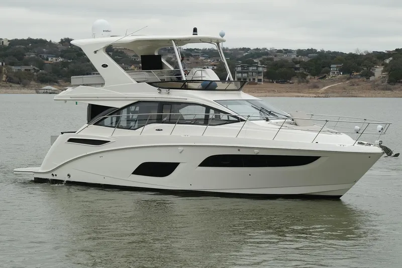 The Image of 2018 Sea Ray Fly 460 yacht on calm water, showcasing sleek design and modern features. - 0