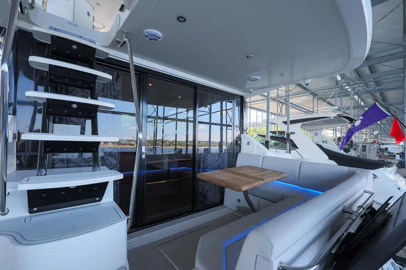 Slide: The Image of 2018 Sea Ray Fly 460 yacht interior with modern seating and sleek design. - 32