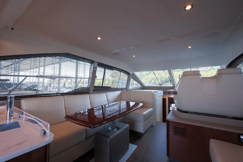 Slide: The Image of Luxurious interior of 2018 Sea Ray Fly 460 yacht with elegant seating and panoramic windows. - 34
