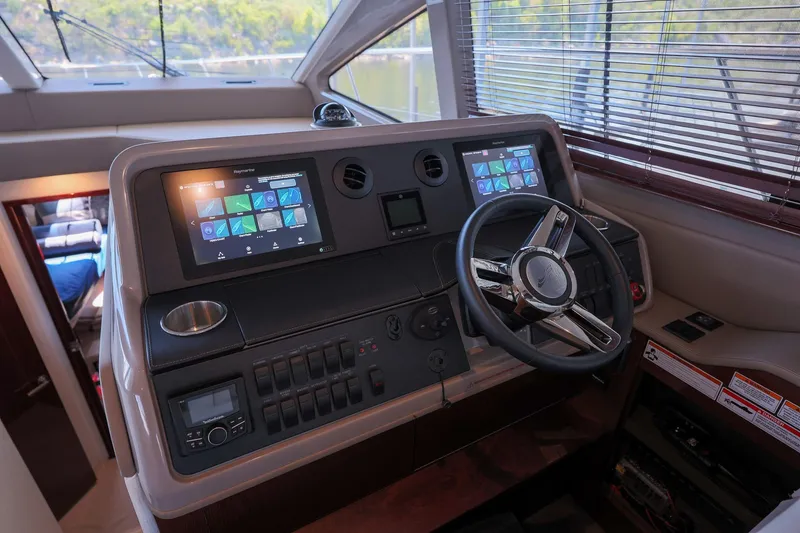 Slide: The Image of 2018 Sea Ray Fly 460 yacht helm with modern navigation displays and controls. - 36