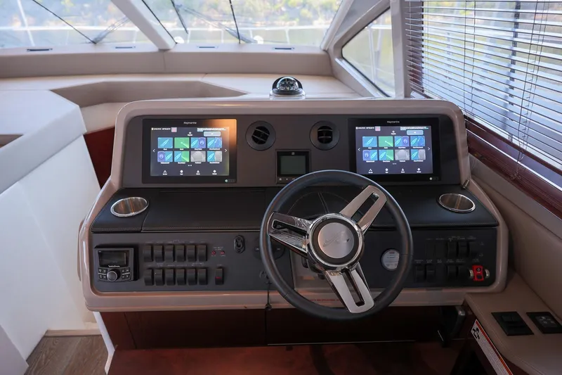 Slide: The Image of 2018 Sea Ray Fly 460 yacht helm with dual touchscreen displays and modern controls. - 37