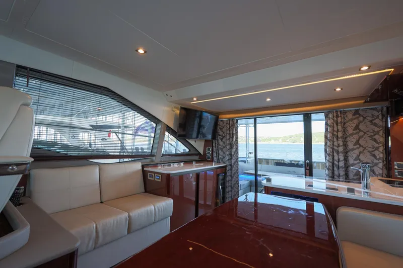 Slide: The Image of Luxurious interior of 2018 Sea Ray Fly 460 yacht with elegant seating and panoramic windows. - 38