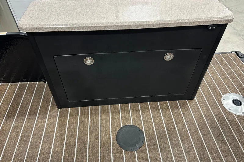 Slide: The Image of 2026 Premier 250 Solaris RS boat interior with striped flooring and storage compartment. - 14
