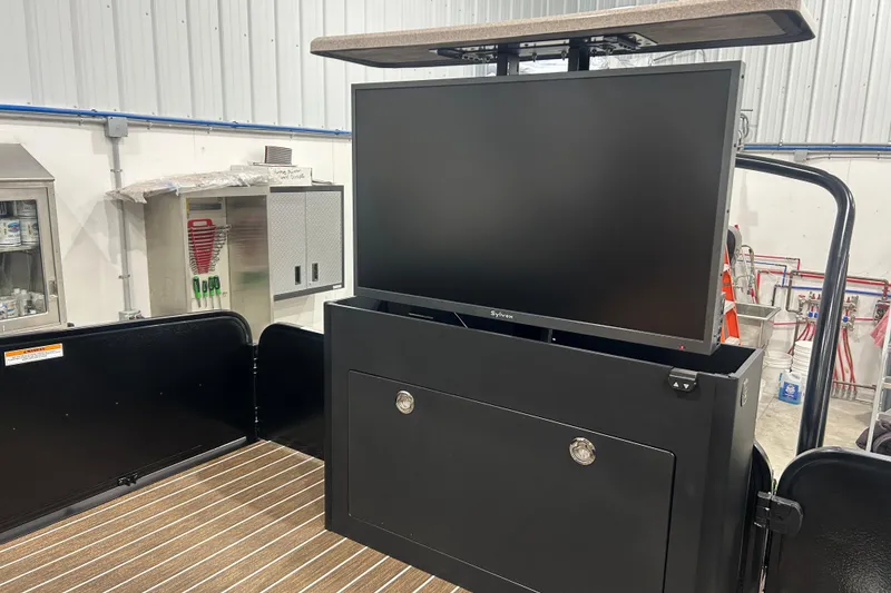 Slide: The Image of 2026 Premier 250 Solaris RS with retractable TV in a workshop setting. - 16