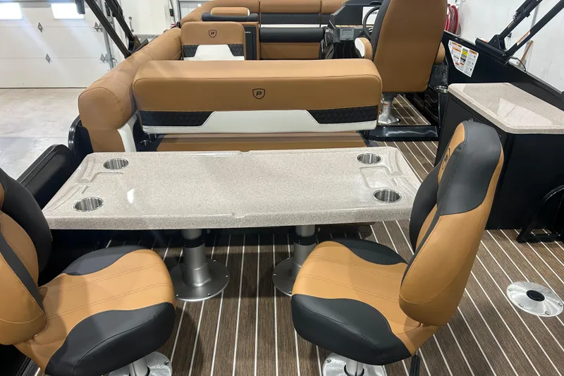 Slide: The Image of Luxurious interior of 2026 Premier 250 Solaris RS boat with tan seating and table. - 22
