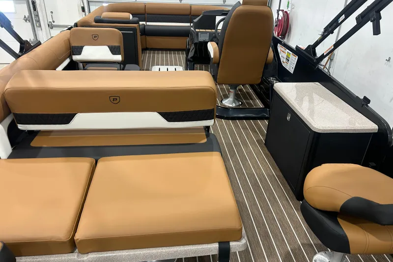 Slide: The Image of 2026 Premier 250 Solaris RS boat interior with tan seating and striped flooring. - 23