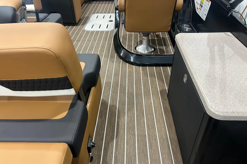 Slide: The Image of Interior of 2026 Premier 250 Solaris RS boat with tan seating and striped flooring. - 24