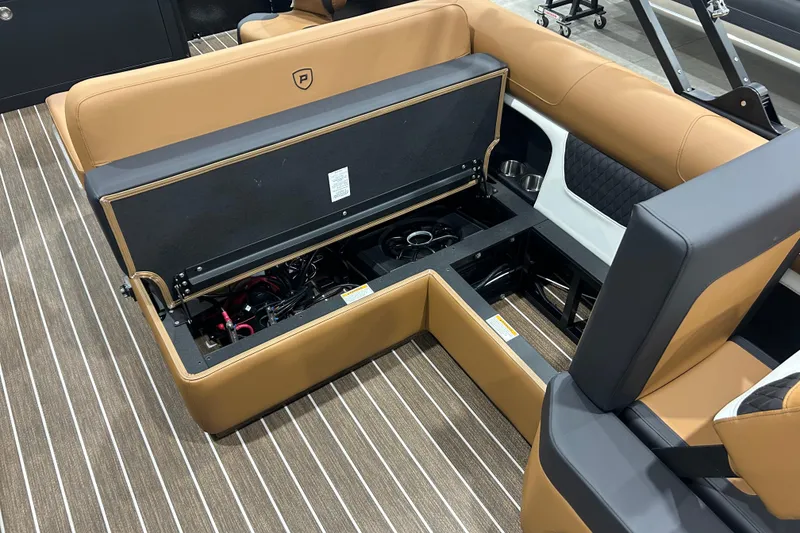 Slide: The Image of 2026 Premier 250 Solaris RS boat interior with open storage compartment and tan seating. - 30