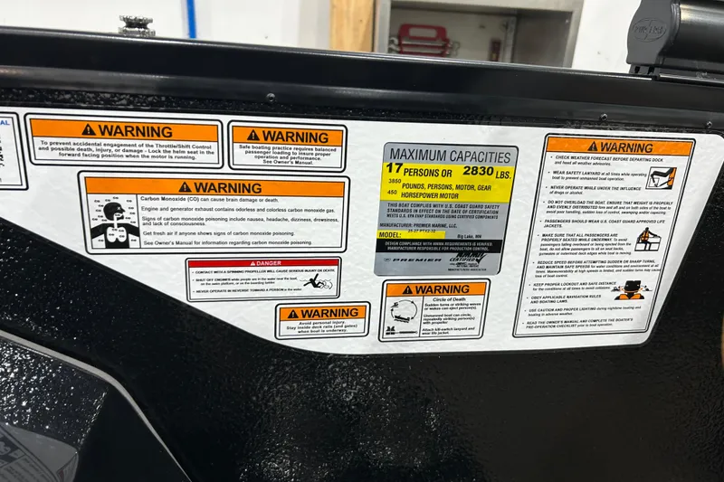 Slide: The Image of Warning labels on 2026 Premier 250 Solaris RS boat, detailing safety and capacity information. - 35