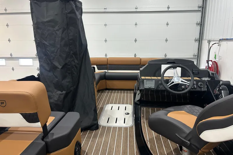 Slide: The Image of 2026 Premier 250 Solaris RS boat interior with brown seating and modern steering console. - 37