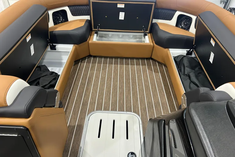 Slide: The Image of 2026 Premier 250 Solaris RS boat interior with open storage compartments and striped flooring. - 41