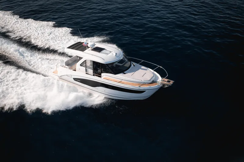 Slide: The Image of 2027 Beneteau Antares 9 V2 cruising on open water, showcasing sleek design and performance. - 13