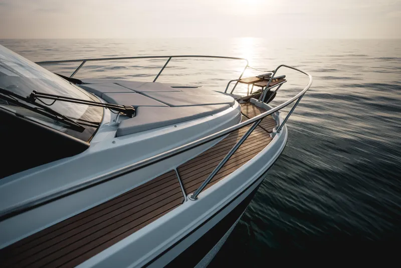 Slide: The Image of 2027 Beneteau Antares 9 V2 yacht on calm sea at sunset. - 14