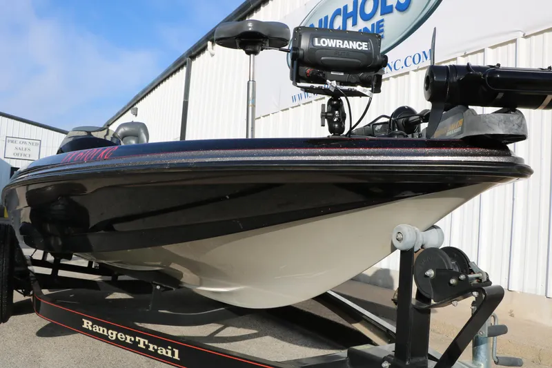 Slide: The Image of 2004 Ranger 185 VS boat on trailer with Lowrance equipment, parked outside dealership. - 13