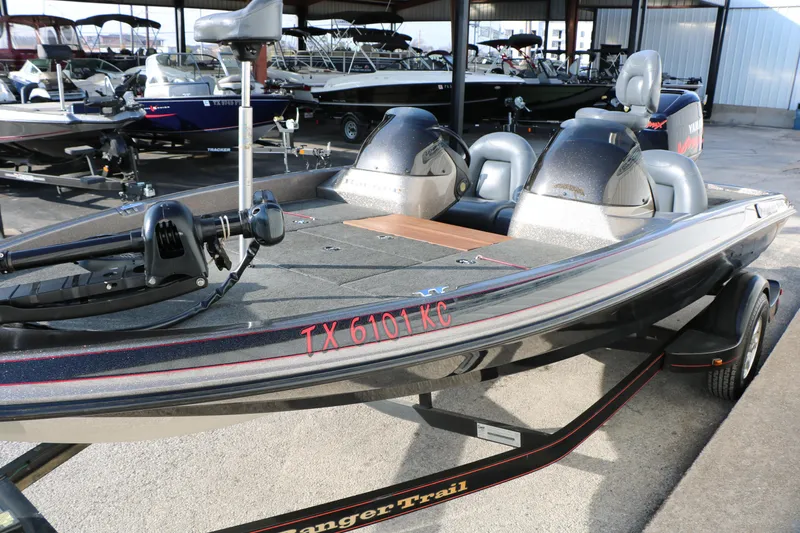 Slide: The Image of 2004 Ranger 185 VS boat on trailer in a marina setting. - 15