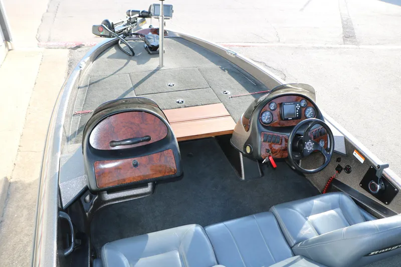 Slide: The Image of 2004 Ranger 185 VS boat interior with steering wheel, dashboard, and seating. - 17