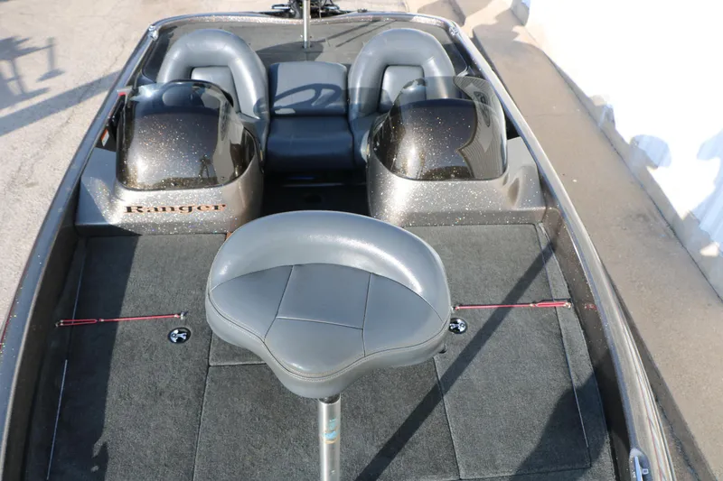 Slide: The Image of 2004 Ranger 185 VS boat interior with gray seating and carpeted deck. - 22