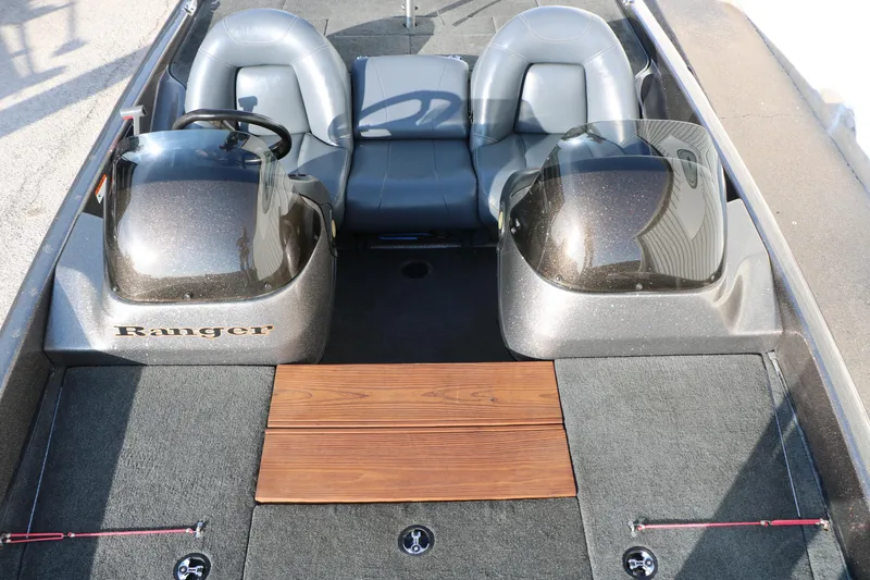 Slide: The Image of 2004 Ranger 185 VS boat interior with dual seats and steering wheel. - 24