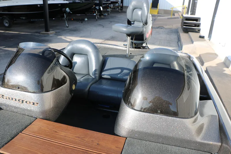 Slide: The Image of 2004 Ranger 185 VS boat interior with dual consoles and seating. - 28