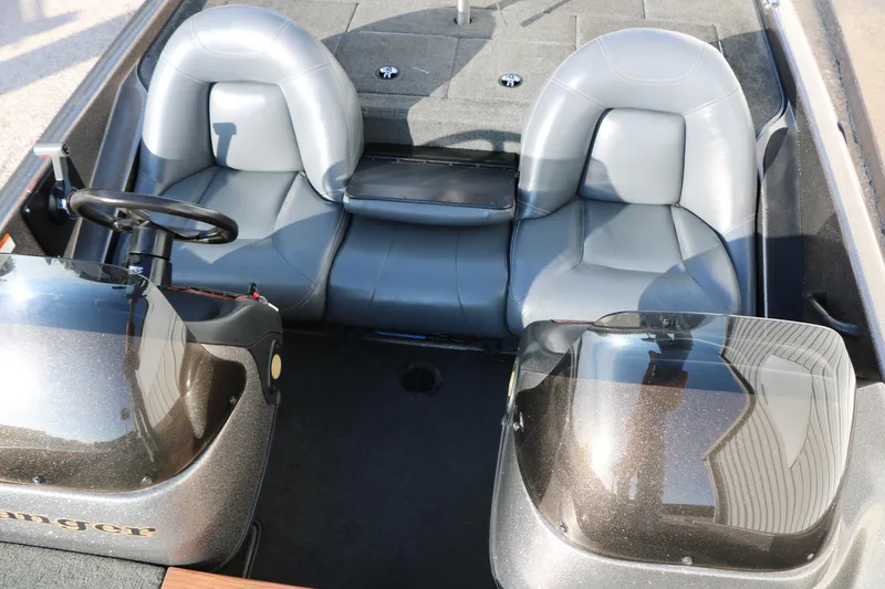 Slide: The Image of 2004 Ranger 185 VS boat interior with dual gray seats and steering console. - 31