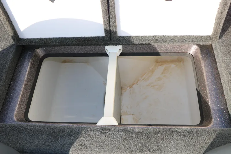 Slide: The Image of Open storage compartment in 2004 Ranger 185 VS boat, featuring a divided interior. - 32