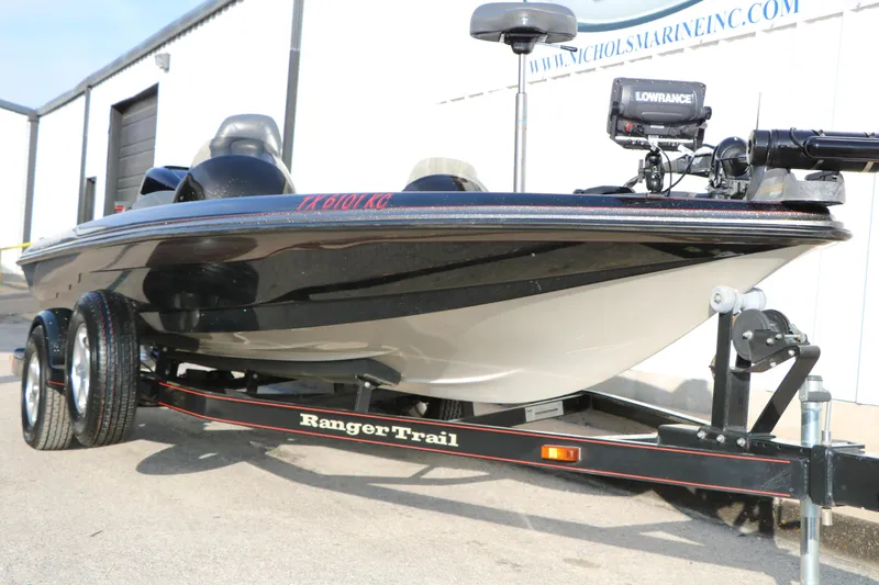 Slide: The Image of 2004 Ranger 185 VS boat on trailer, featuring Lowrance equipment, parked outside a marine facility. - 4