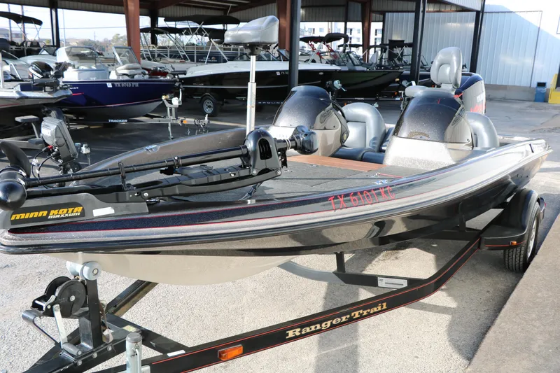 Slide: The Image of 2004 Ranger 185 VS boat on trailer in marina, featuring Minn Kota trolling motor. - 7